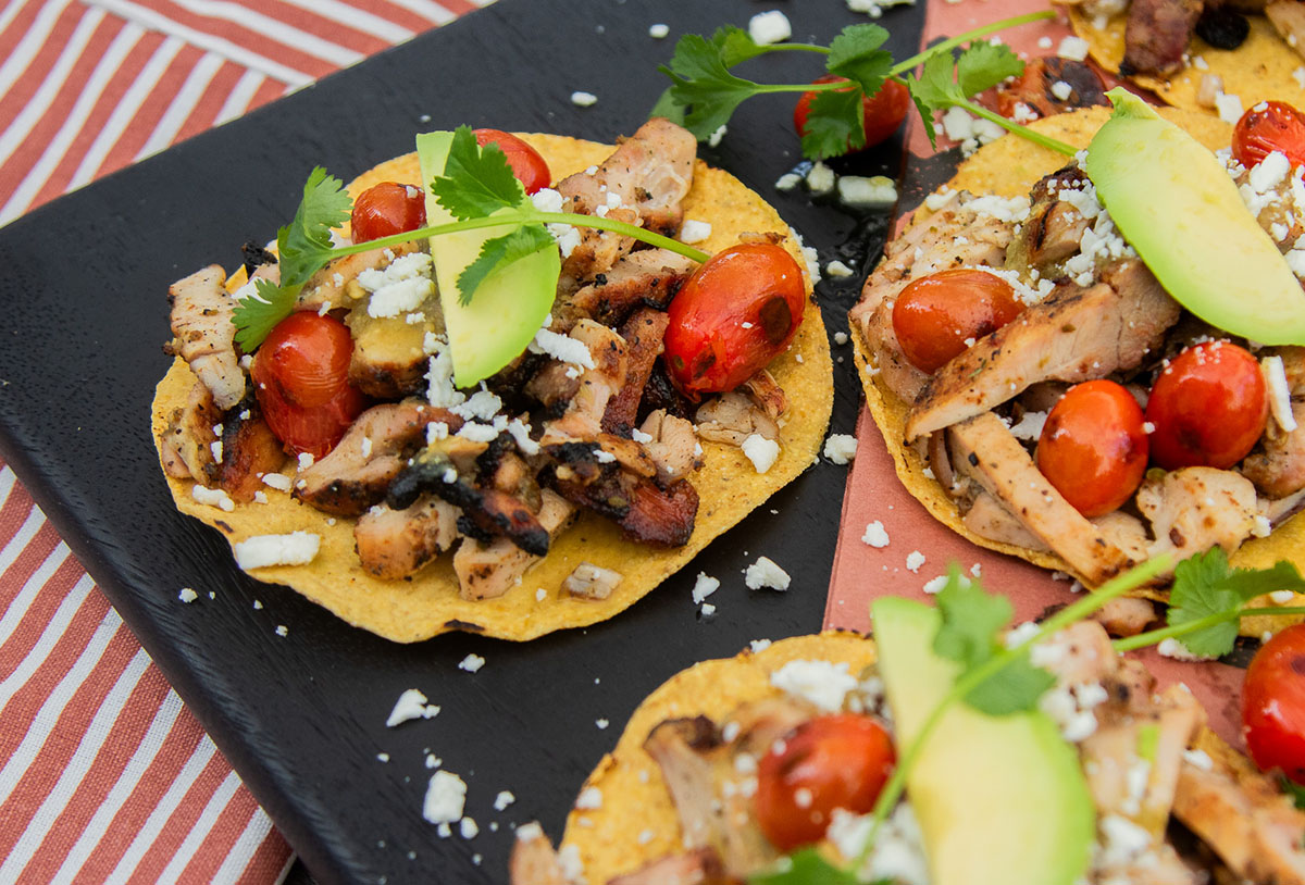 grilled chicken tostadas cooked on pit boss wood pellet grill topped with cheese, salsa, and veggies