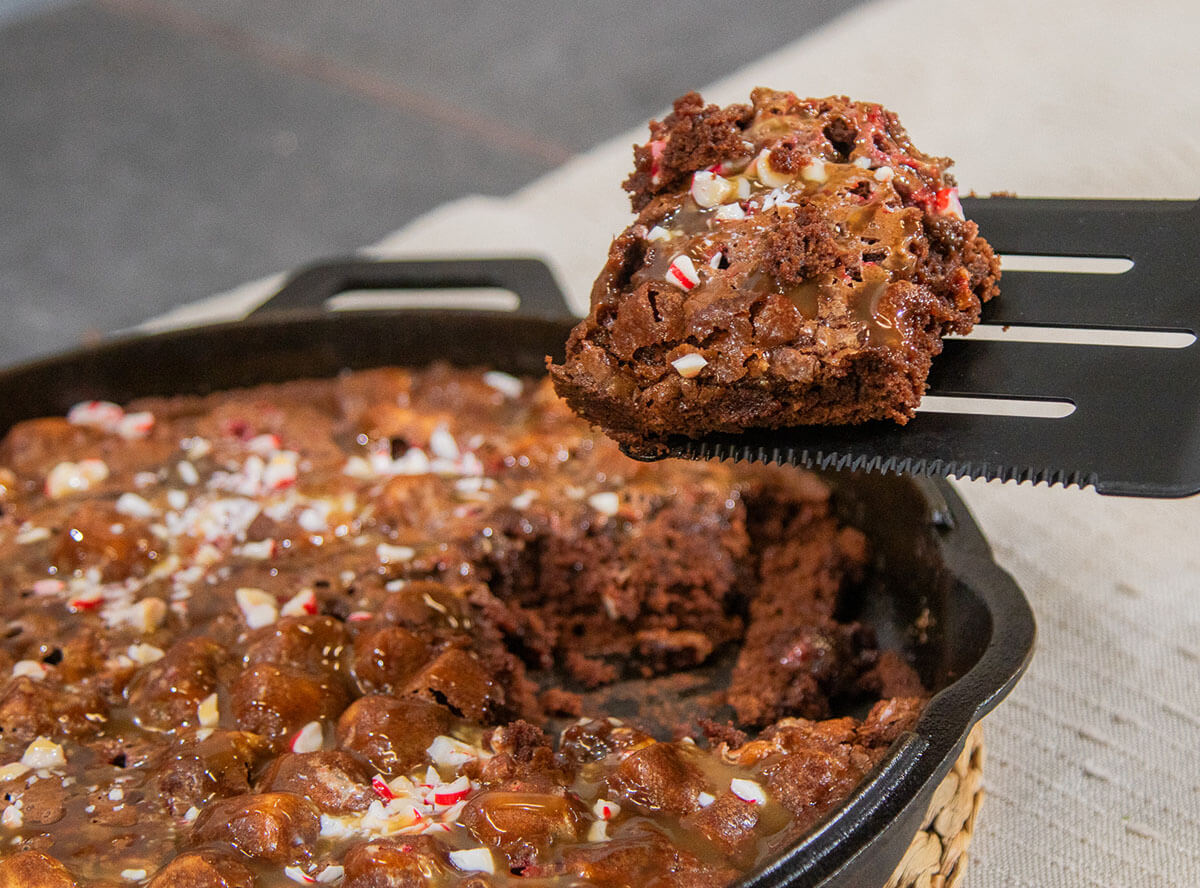 baked skillet brownies cooked on pit boss wood pellet grill and topped with peppermints and caramel sauce