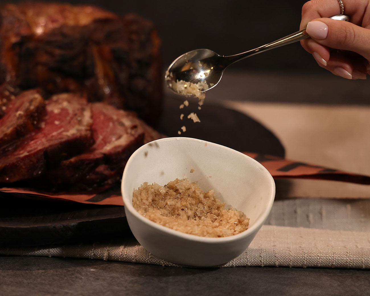 smoked sea salt cold smoked on pit boss wood pellet grill. served in white bowl alongside carved prime rib